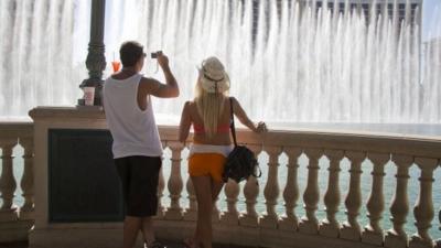 Tourists watch the Bellagio fountain show during a heat wave