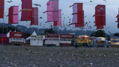 The field in front of the Other Stage is covered in litter at the Glastonbury music festival