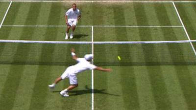 Viktor Troicki attempts to hit the ball with his hand after dropping his racket