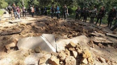 Thai security personnel inspect the site of a bomb attack by suspected Muslim militants on a roadside in Yala province, south of Bangkok, on Saturday