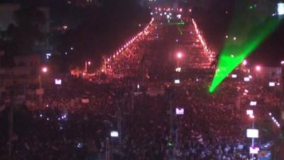 A bridge leading to Tahrir Square filled with protesters and dotted with lasers on the night of June 30 2013