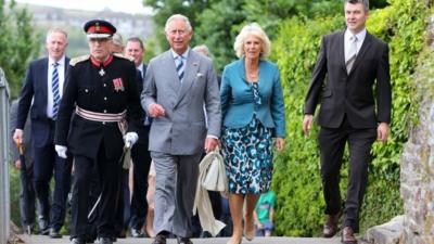 Prince Charles and the Duchess of Cornwall walk to the Boathouse in Laugharne