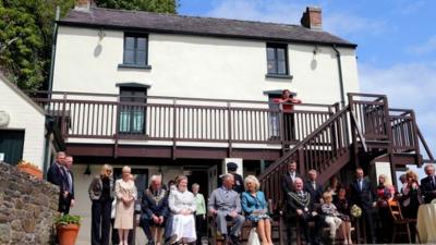 Prince Charles and the Duchess of Cornwall at the Boathouse in Laugharne to watch the performance