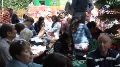 People sit in the queue for Wimbledon