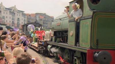 The Gromit statues arrive onboard a train