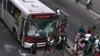 Protestors attack a bus in Manaus