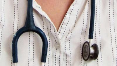 A stethoscope around a man's neck