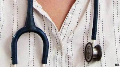 A stethoscope around a man's neck