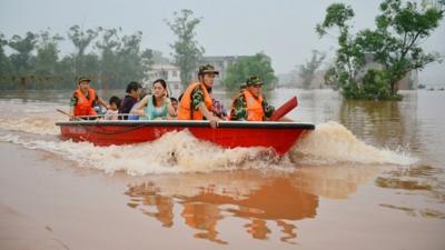 Rescuers evacuate residents from flood-hit areas of Chongqing, China