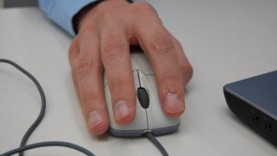 Man using a laptop mouse