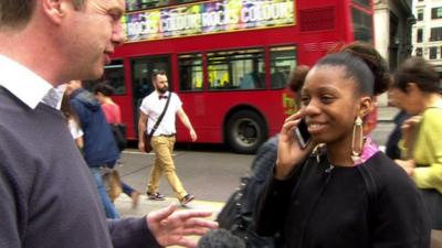Woman on phone while talking to BBC reporter Graham Satchell