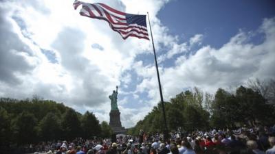 Visitors to the Statue of Liberty disembark onto Liberty Island from the first ferry to leave Manhattan as the landmark reopens on Independence Day