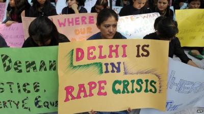 Women from India"s North Eastern states hold placards during a peaceful protest against the rape of a girl from Mizoram