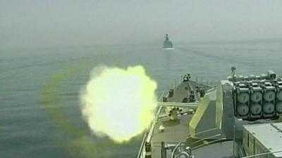 Rounds are fired from a ship during a joint naval exercise between China and Russia