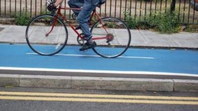 Person riding a bicycle on a Barclays Cycle Superhighway