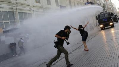 Riot police use a water cannon to disperse demonstrators during a protest in central Istanbul