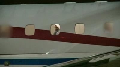 Radical cleric Abu Qatada looks out the window of the plane