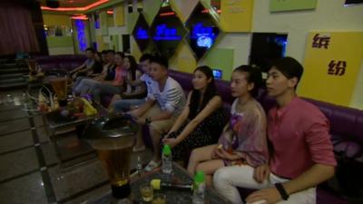 Chinese graduates in karaoke bar