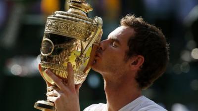 Andy Murray kisses the Wimbledon trophy