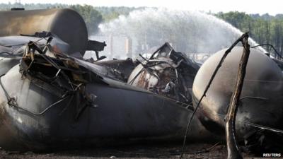 A burnt tree stands near the remains of a train derailment in Lac Megantic, Quebec