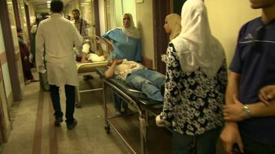 Hospital corridor in Cairo with patients on trolleys