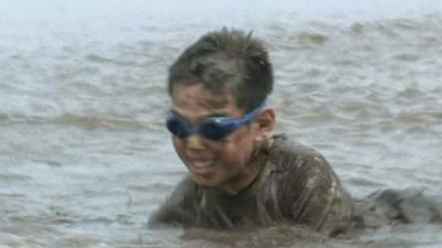 Child playing in mud in Ono City in Japan