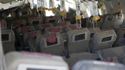 Inside Asiana Flight 214 oxygen masks can be seen hanging from the ceiling