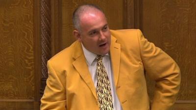 Robert Halfon in tangerine-coloured suit