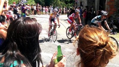 Fans cheer on riders in the Tour de France as they pass through Mijanes in the French Pyrenees