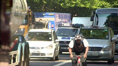 Cyclist on busy road