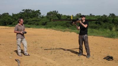 Two men about to fly a drone aircraft in Sumatra