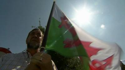 One of the Welsh memorial supporters with a Welsh flag in Flanders, Belgium