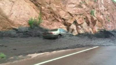 The car is swept away by the mudslide