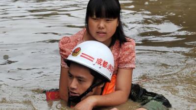 Rescuer carrying girl