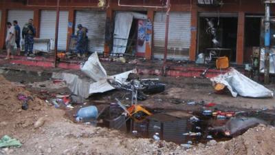 Security forces inspect the scene of a suicide bomb in Kirkuk, Iraq