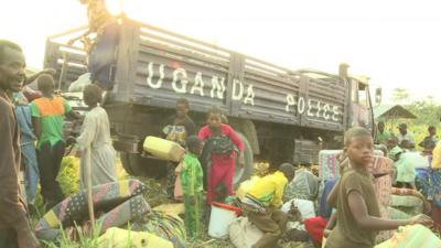 Refugees next to truck