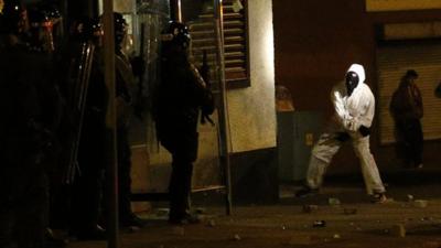 A loyalist rioter attacks riot police in the Woodvale area of north Belfast, Northern Ireland, Monday, July 15, 2013