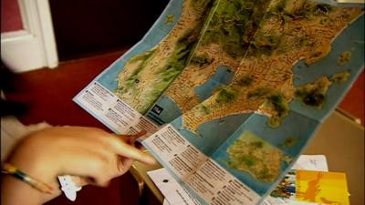 Pilgrims check out a map of Brazil