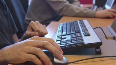 Young male sitting at computer