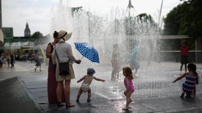 Children play in the fountain "Appearing Rooms", by Danish artist Jeppe Hein, on the Southbank in high temperatures