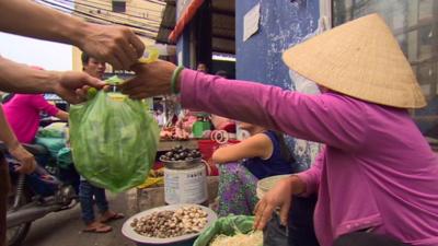 Woman selling lettuce in Vietnam