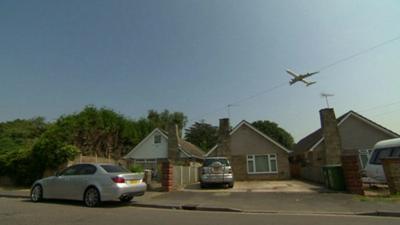 Plane flying over homes