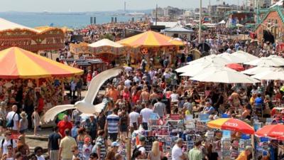 A packed Brighton beach in East Sussex as sunbathers enjoy the sunshine