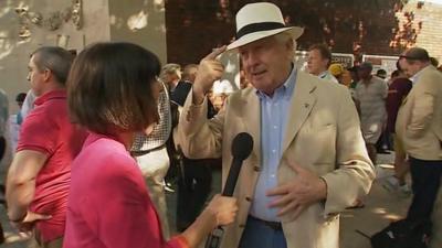 Spectator Bill points out his linen jacket and panama hat