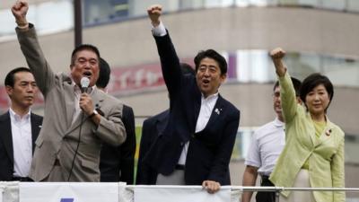 Japan's Prime Minister Shinzo Abe (C), who is also leader of the ruling Liberal Democratic Party (LDP), raises his fist with his party members at the start day of campaigning for the 21 July upper house election in Tokyo, 4 July 2013