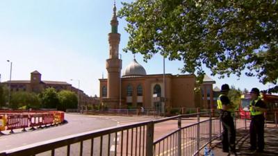 Police officers stand near Wolverhampton Central Mosque