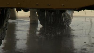 Underneath an armoured vehicle being washed in Afghanistan