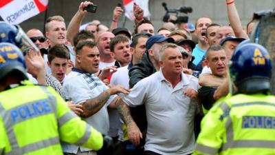 EDL members clash with the police during a EDL march at Centenary Square in Birmingham