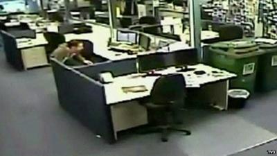 An employee takes cover in a New Zealand office