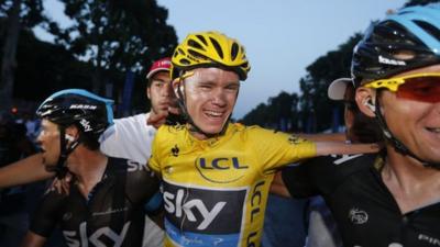 Tour de France 2013 winner Britain"s Christopher Froome (C) celebrates with teammates on the Champs-Elysee avenue in Paris